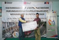 Vice President Daop 7 Madiun, Suharjono (kiri) menyerahkan bantuan dari PT KAI Daop 7 Madiun kepada LKSA Muhammadiyah Kota Madiun, Minggu (3/8/2025).